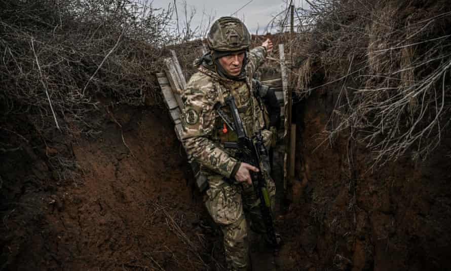 Ukrainian troops patrol at the frontline outside the town of Novoluhanske, eastern Ukraine.