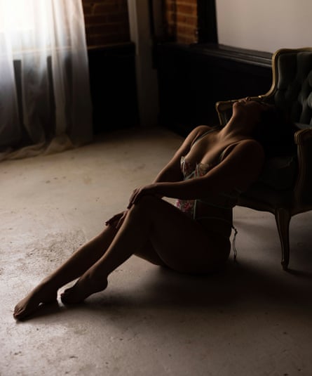 Brittany lying back in a chair wearing lingerie