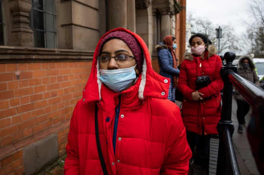 Poonam waiting in line for a free hot meal.