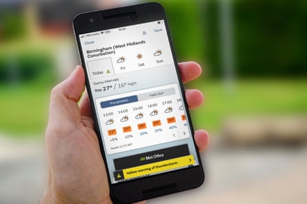 A weather app on a phone is shown to the camera