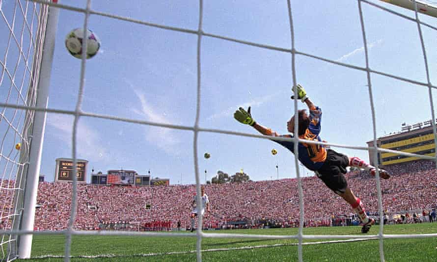 Brandi Chastain fires her surprisingly left-foot penalty past China’s goalkeeper Gao Hong to win the World Cup for the USA.
