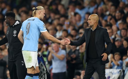 Pep Guardiola greets Erling Haaland as he comes off the pitch against Napoli.