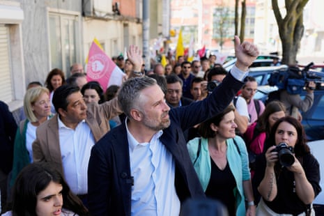 Socialist Party secretary general Pedro Nuno Santos gestures to supporters while walking to an election campaign event in Amadora, outside Lisbon.
