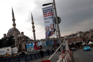 An election banner with the pictures of Turkish President Erdogan and AK Party mayoral candidate Yildirim is seen over the Galata bridge in Istanbul.