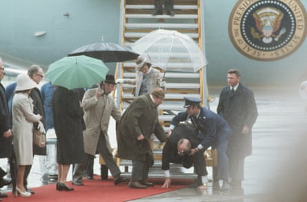 President Ford slips as he exits Air Force One, 1975.