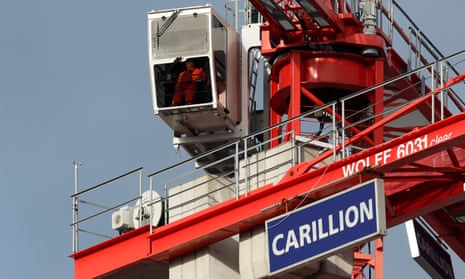 A worker operates a crane on a Carillion construction site in Smethwick