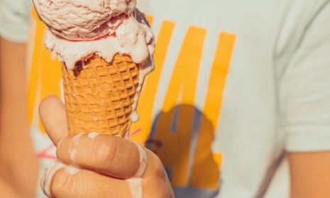Holding an ice-cream cone.
