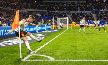 Toni Kroos takes a corner in a friendly against France