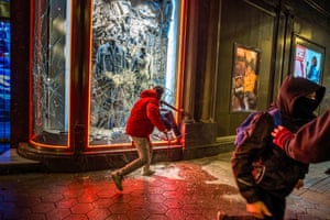 Protestors break the window of  the Diesel store on Passeig de Gràcia during the demonstration in response to the arrest and imprisonment of rapper Pablo Hasel who is accused of exalting terrorism and insulting the crown with the content of the lyrics of his songs.