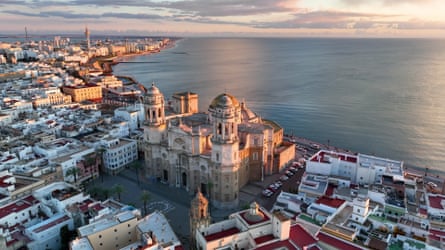 Sunset view of Cádiz Cathedral with surrounding town and sea