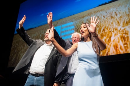 Congressional candidate James Thompson, Senator Bernie Sanders and Alexandria Ocasio-Cortez, wave at the end of the campaign event.