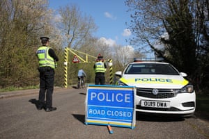 Police officers patrol the entrance to Nene Park in Peterborough, Cambridgeshire