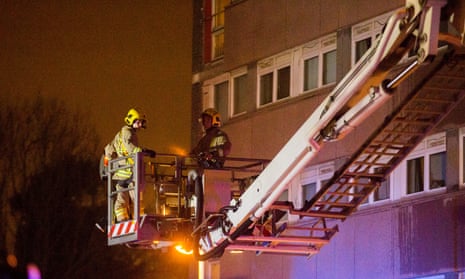Firefighters at the scene of a fire at Coolmoyne House in Dunmurry, Belfast.