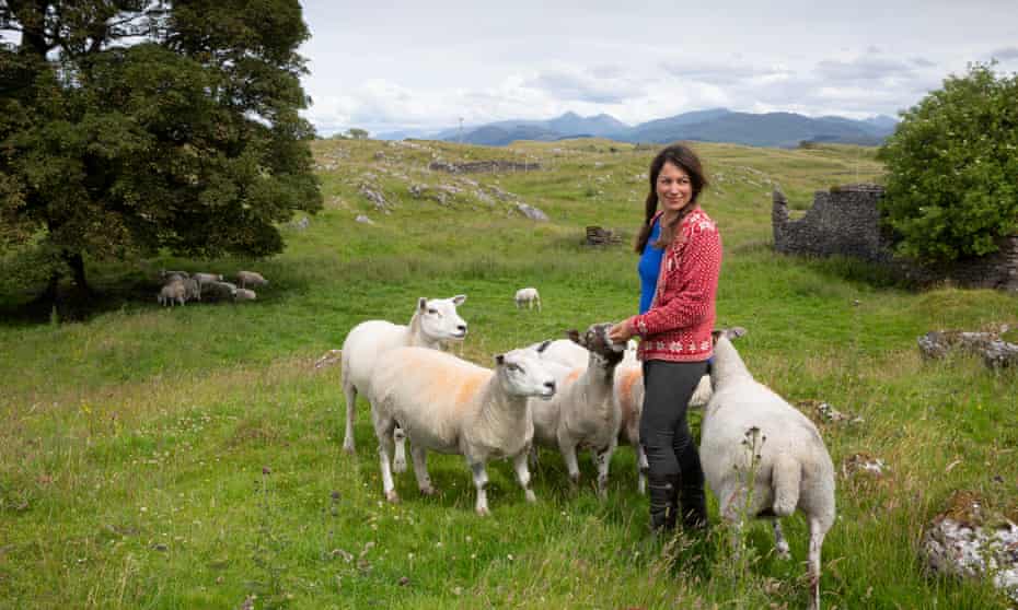 Tamsin Calidas with a few sheep around her on a remote Scottish island