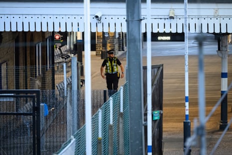 A police officer walks on the platform after a stabbing attack on board a Doncaster-London King’s Cross train on Saturday.