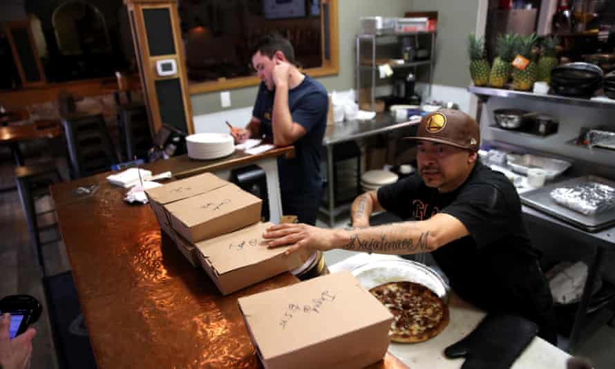 A worker prepares to-go orders at Creekside Pizza and Taproom in San Anselmo, California.