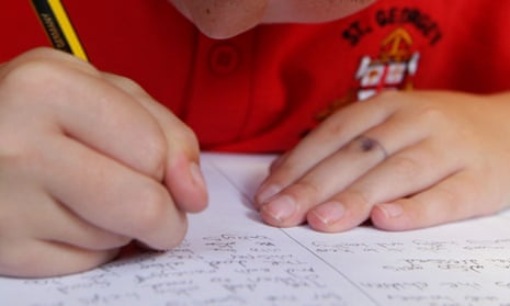 A pupil writing in an exercise book