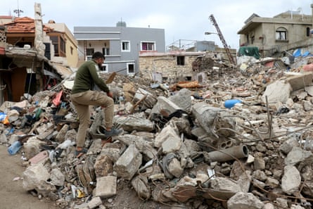 A man examines rubble after returning to Srifa on Sunday.