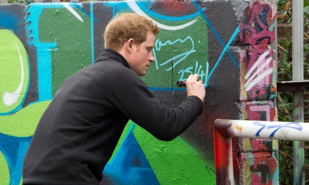 Prince Harry adds his tag to a wall at a Nottingham youth club in 2013.