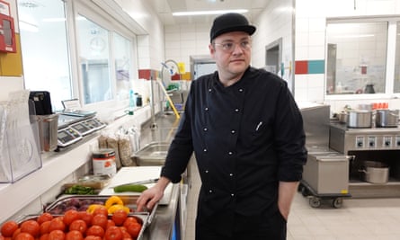 Patrick Burrichter in his kitchen standing by some vegetables.