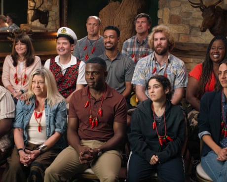 A group of people sitting in rows of chairs listening to someone out of shot