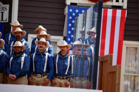 Men stand on stage