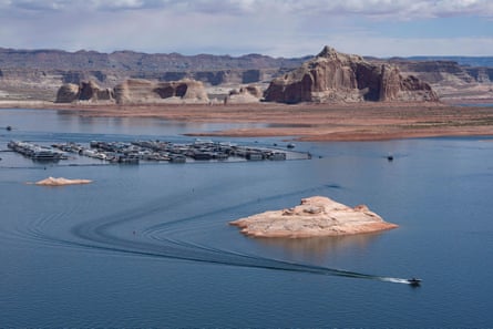 Boats on a body of water with mountains in the background