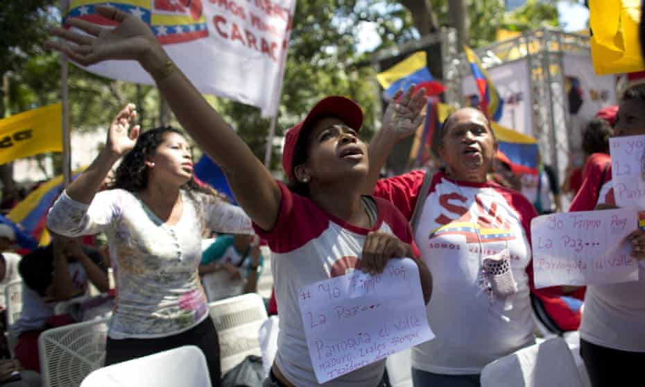 Supporters of Nicolás Maduro sing a song about Venezuela’s late president Hugo Chávez during a demonstration in Plaza Bolívar, Caracas.