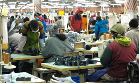 Textile workers at a factory making jeans