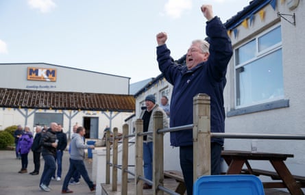 A member of the ‘Lowerhouse Ultras’ cheers on the home team from his usual position in front of the clubhouse.