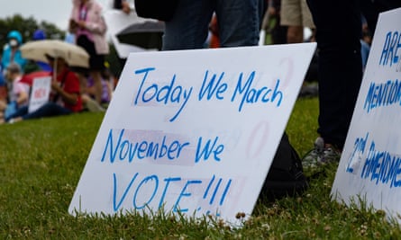 A sign rests on the ground reading ‘today we march November we vote’