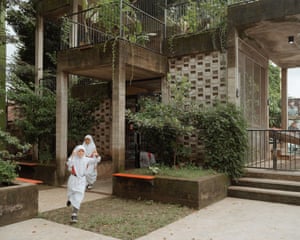 two children walk outside of building