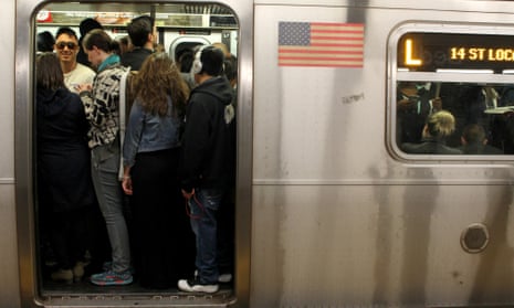 Passengers pack themselves onto a crowded L train.