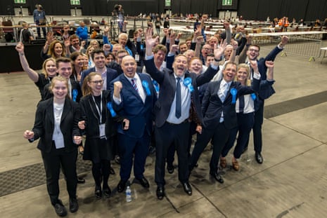 Douglas Lumsden (front row, centre) and Andrew Bowie (front, right) celebrating with supporters after the byelection win.