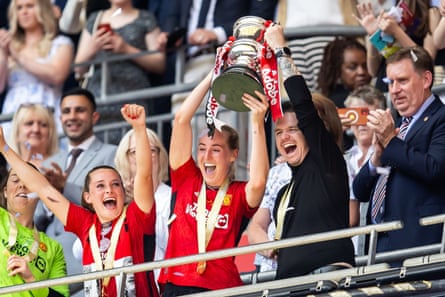 Marc Skinner and Millie Turner lift the FA Cup after the 2024 final