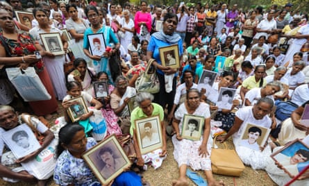Sri Lankans hold portraits of relatives who disappeared during a protest to demand an investigation, in Colombo, on 14 February 2020.