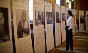 A visitor studies stories of Holocaust victims during the annual Holocaust memorial commemoration event at the Foreign & Commonwealth Office on 23 January.