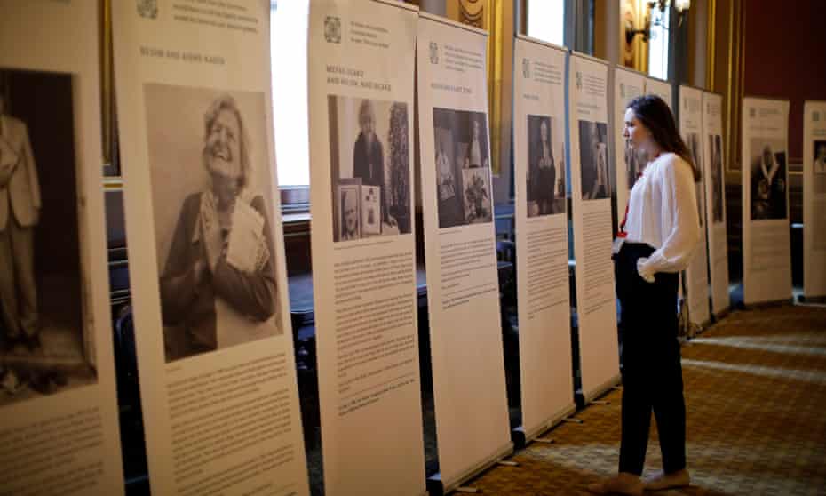 A visitor studies stories of Holocaust victims during the annual Holocaust memorial commemoration event at the Foreign &amp; Commonwealth Office on 23 January.