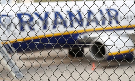 Ryanair plane seen through a fence.