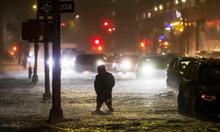 A man navigates a street flooded by heavy rain as remnants of Hurricane Ida hit the area in the Queens, New York, in September.