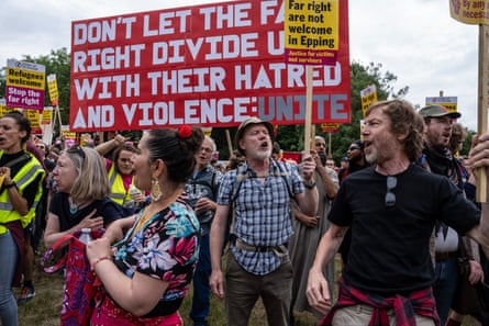 Counter-protesters hold banners and signs with messages including ‘Far right are not welcome in Epping’ and ‘Don’t let the far right divide you with their hatred and violence’.