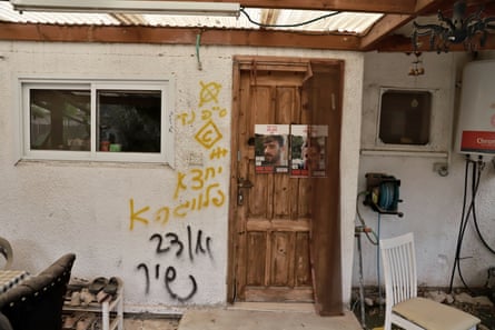 Front door of home with graffitied wall