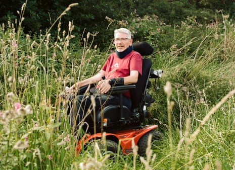 Ian Flatt, who is living with cancer, in his off-road wheelchair in a field