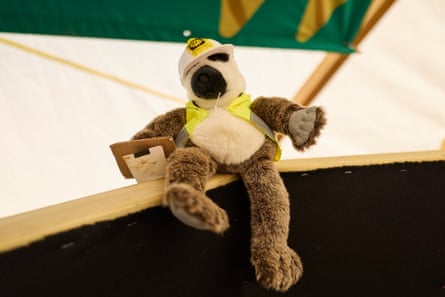Monkey in hard hat holds clipboard