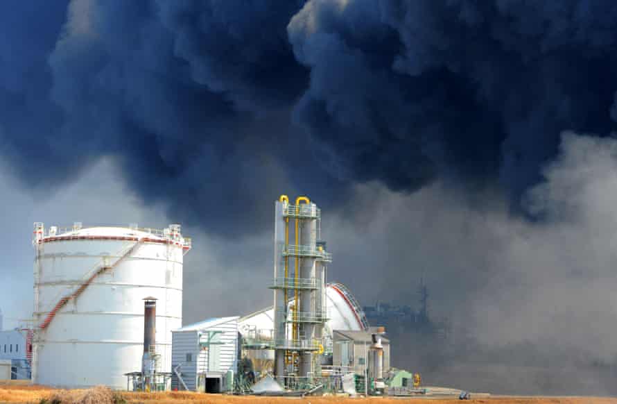 Smoke billows from fires raging at the port in Tagajo, Miyagi prefecture, in March 2011 after a massive earthquake and tsunami.