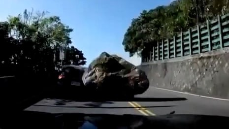 Taiwan earthquake sends boulder crashing into car – video 