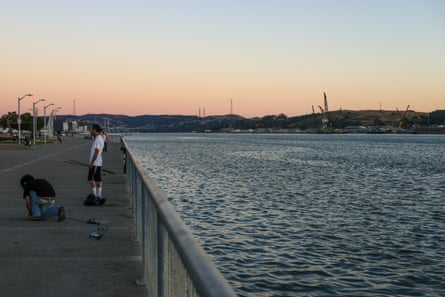 Youth fish at a waterfront