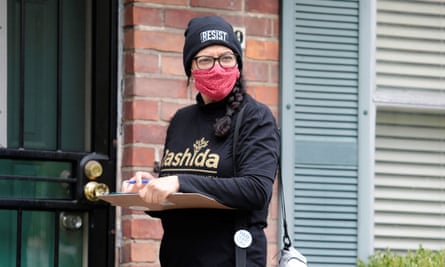 Rashida Tlaib knocks on doors in Detroit on 18 October to encourage residents to vote.