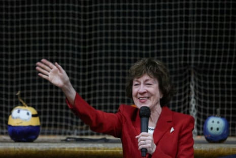 Collins holding a microphone and waving