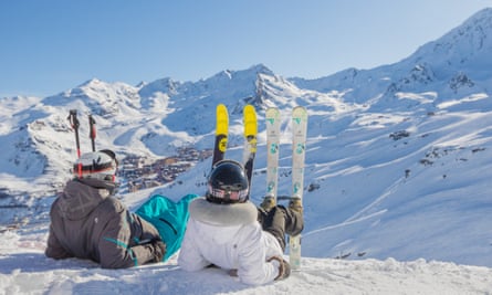 Skiers take a break in the snow at Val Thorens, from Montagnes.